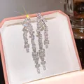 Detailed macro view of super shiny cubic zirconia double-row tassel drop earrings in a gift box - Double Row Tassel Style (HE34169) / Silver