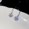 Close-up of micro-paved cubic zirconia round ear hook earrings with minimalist luxury design. - Silver