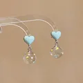 Charming blue heart dangle earrings featuring clear glass balls with colorful polka dots - Heart Style
