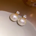 Detailed close-up of elegant cotton pearl earrings with sparkling square zirconia - Silver Needle Gold Style / White