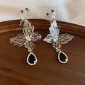 Detailed view of hollow butterfly earrings with black teardrop crystal pendant - Black Water Drop (HE34287) / Silver