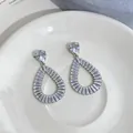 Detailed close-up showing intricate hollow teardrop design of silver zircon earrings. - Hollow Water Drop Style (HE33635) / Silver
