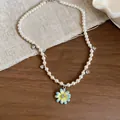 Detailed view of pearl necklace with blue flower pendant and heart zircon charms - White-Blue