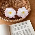 Detail view of sweet pink and white fabric flower hair claw clip on a wicker basket. - Shark Clips / Single Piece / Pink
