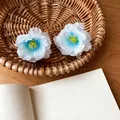 Detailed shot of two blue and white gradient fabric flower hair claw clips in a basket - Shark Clips / Single Piece / Blue