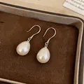 Close-up of elegant teardrop pearl earrings with silver hooks in a jewelry box - Earring Hooks - Silver / White