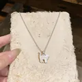 Detail macro of a delicate cat pendant necklace with shell inlay on textured paper. - Cat Silhouette Pendant (O Chain) / Silver