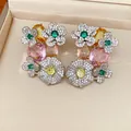 Macro detail of luxury vintage floral earrings with colorful gemstones and zirconia. - Silver