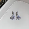 Close-up of luxurious pear-shaped zircon earrings with sparkling silver finish. - Earrings Only (Silver Earring Post) / Silver-White