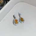 Detailed close-up of luxury yellow pear-cut zircon earrings featuring a sparkling halo effect - Earrings Only (Silver Earring Post) / Silver-Yellow