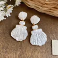 Detailed view of French vintage shell earrings with an elegant pearlescent finish - 3-Segment Shell Style / 925 Silver Needle / White