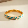 Elegant gold-tone bangle bracelet featuring teal and pink marble enamel oil-drip design - Gold, White and Cyan