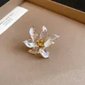 Macro detail of pearlescent tulip flower ring with elegant gold center and vintage style - Open Ring / White