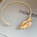 Detailed view of a golden calla lily flower choker necklace with elegant white pearls. - Choker-Gold (Pearl Style)