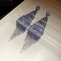 Close-up of sparkling blue and silver rhinestone tassel earrings in diamond shape - Rhombus Tassel Style / Gradient Blue