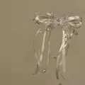 Close-up detail of a cream satin bow hair clip with rhinestone butterfly and tassels - Duckbill Clip (HH9866) / White