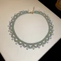 Handcrafted light blue beaded choker necklace with teardrop pearls and gold accents - Pearl Pendant Style / Gold Blue White