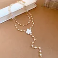 Elegant double-layered pearl necklace featuring a delicate white flower pendant detail. - Necklace / Gold-White