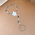 Detailed view of silver hand chain featuring a white resin flower and colorful rhinestones - Ring and Bracelet Integrated Chain / Silver-White-Multicolor