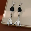 Detailed view of vintage teardrop earrings with black gems and pearl tassels - Black Teardrop Tassel Style / Silver