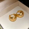 Close-up of vintage gold hoop earrings with matte finish and starburst crystal details - Hoop Earrings-Gold