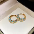 Close-up of vintage gold hoop earrings with turquoise and white stones in a gift box - Hoop-Gold-Blue
