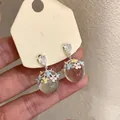 Detailed shot of resin sphere drop earrings with colorful enamel flowers and crystals. - Silver Needle Multicolor Flowers / Silver - Rainbow