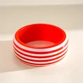 Macro view of a chunky resin bangle with vibrant red and white horizontal stripes - Red and White Striped