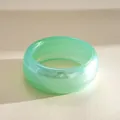 Macro view showing the translucent texture and stripes of the green resin chunky bracelet - Iridescent Cyan