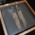 Close-up view of elegant silver-tone rhinestone tassel dangle earrings in a gift box - 55# Ear Hook - Silver