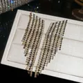 Macro view of luxurious silver needle rhinestone tassel earrings on a textured display tray - 58# Silver Needle - Gold - Black