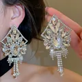 Detailed view of oversized geometric rhinestone tassel earrings worn by a model - 62# Silver Earring Post - Silver