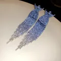 Close-up of sparkling long tassel earrings with heavy rhinestone embellishment - Cross Tassel (6#) / Blue