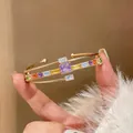 Detail shot of luxury 18k gold plated open cuff bangle with colorful square zircons - Rainbow Square Zirconia Double Layer Bangle (HB5481)