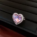 Close-up of a luxury vintage ring with a faceted pink heart zircon and micro-pave crystals - Heart Open Ring / Silver-Pink