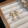 Detailed view of 18k gold plated butterfly stud earrings with zircons and pearls - Butterfly Pearl Drop Style (Silver Post) / Gold