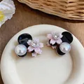 Close-up detail of small pink flower and pearl hair claw clips with rhinestone center - Flower Pearl Style / Single Piece / Pink