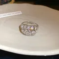 Detail of a geometric 18k gold plated ring with shimmering zirconia stones - Silver