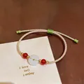 Detailed view of handmade pink and green woven cord bracelet with white jade donut bead - Pink Green Safety Buckle Style