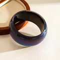 Detailed close-up of a chunky galaxy resin bangle with shimmering purple and blue glitter - Black Starry Iridescent Bangle