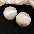Detailed close-up of large brushed silver circular stud earrings with a vintage matte finish - Smooth Round Stud Earrings (HE3602) / Silver