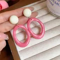 Close-up of pink and white acrylic geometric drop earrings on a jewelry tray - Oval Geometric Style (HE32068) / Pink