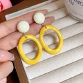 Detail of yellow acrylic oval drop earrings with cream round studs - Oval Geometric Style (HE32068) / Yellow