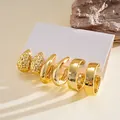 Detailed macro view of 6-piece gold hoop and teardrop stud earring set on white card. - 6-Piece Set (Drop/C-shape Geometric) / 6-Piece Set / Gold
