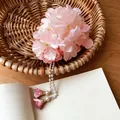 Elegant pink fabric flower hair clip with pearl tassels displayed in a rustic basket scene. - Duckbill Clip - Single Piece / Pink