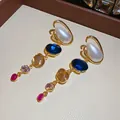 Macro view of multi-color gemstone drop earrings with teardrop pearls in gold setting. - Drop Earrings / 925 Silver Needle / Gold/Blue/White