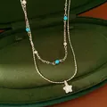 Close-up of elegant double-layer necklace featuring star pendant and beads in velvet box - Stone Style / Silver-Blue