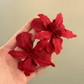 Detailed view of large matte red flower earrings for stylish beach holiday accessories. - Red
