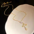 Detail of sparkling 18k gold plated cross pendant necklace with zircon stones. - Necklace / Gold