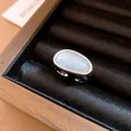Detailed macro view of a minimalist adjustable ring featuring a textured oval gemstone. - Oval Style (HR3659) / Silver